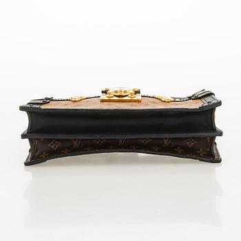 Louis Vuitton, a "Reverse Monogram Trunk Clutch" bag.