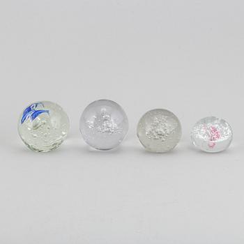 A group of 12 glass paper weights.