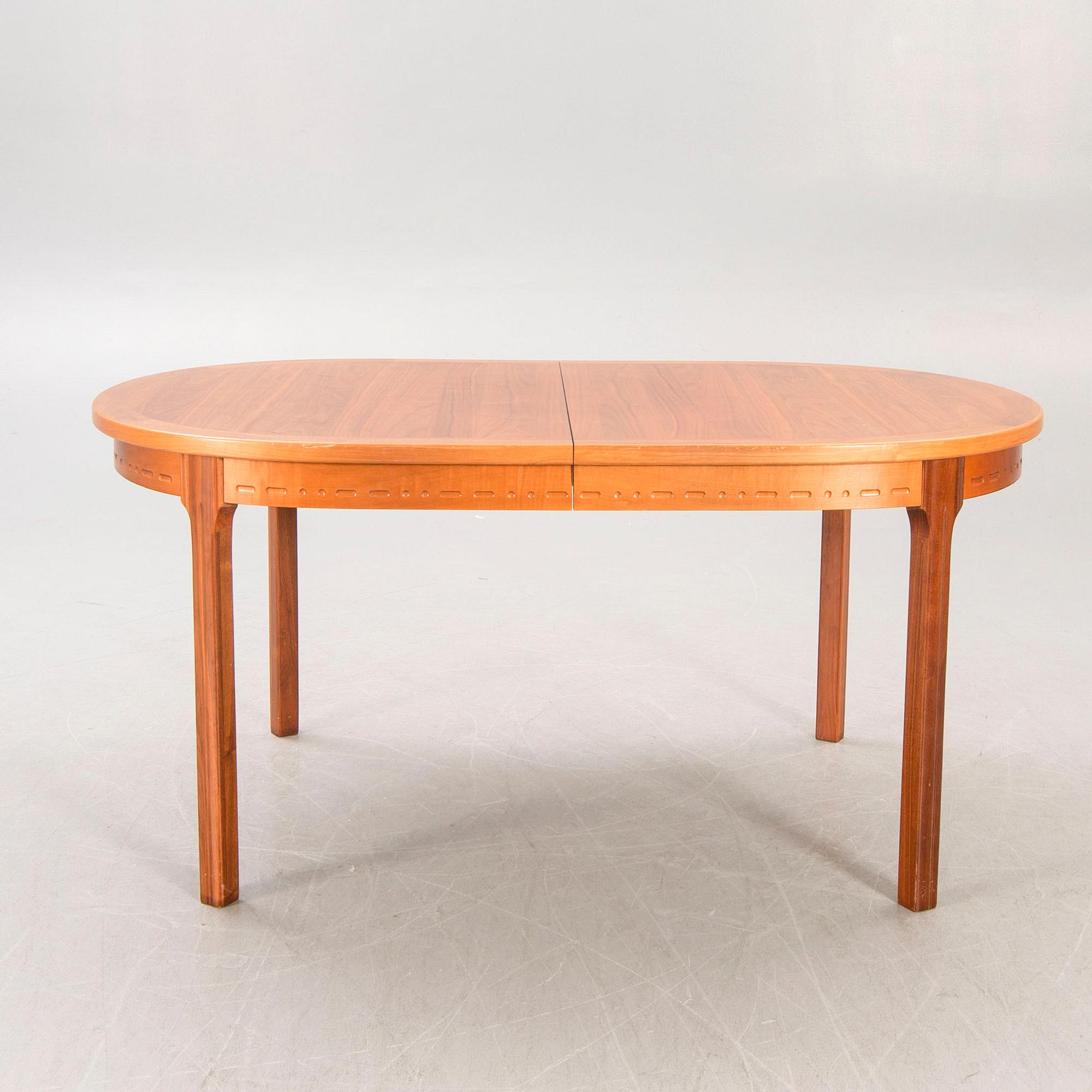 A Nils Jonsson teak and walnut 1960s dining table.