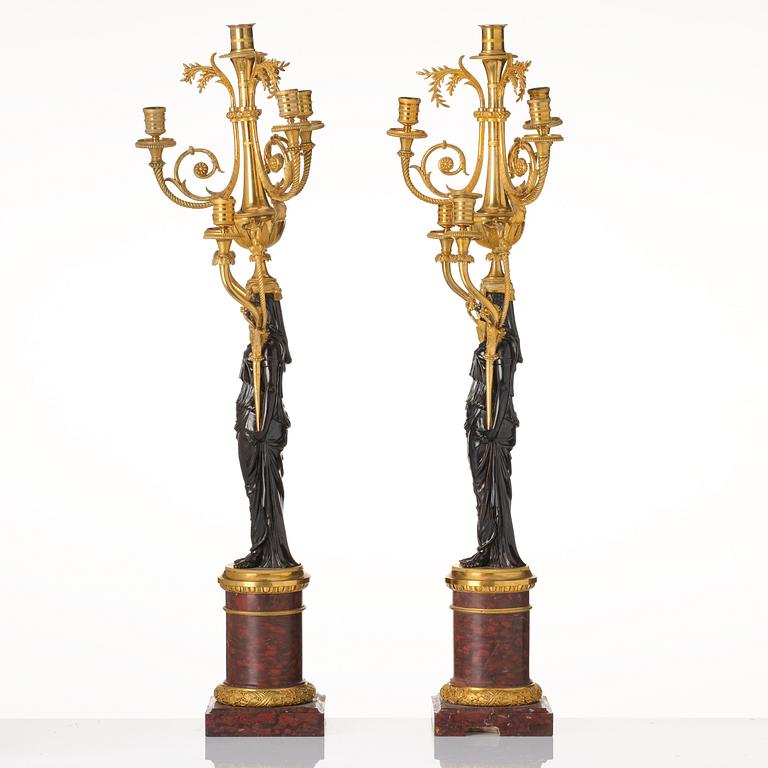 A pair of Louis XVI ormolu and patinated bronze six-branch candelabra attributed to François Rémond, late 18th century.