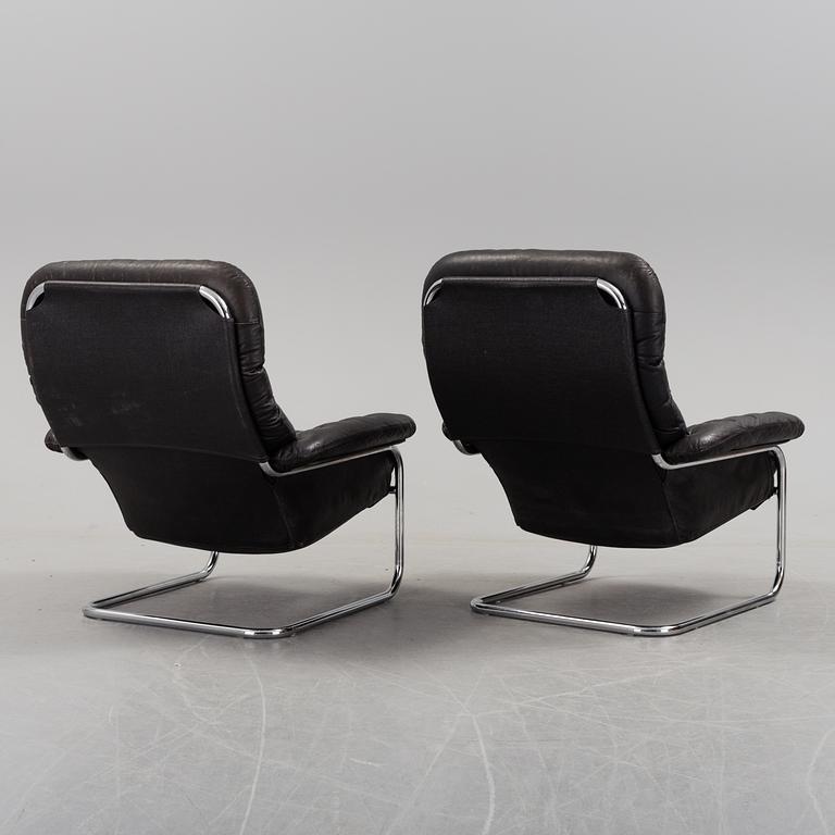 A pair of leather upholstered easy chairs from Dux, late 20th Century.