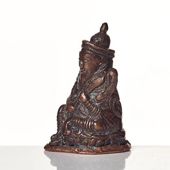 A Tibetan copper alloy figure of a deity.