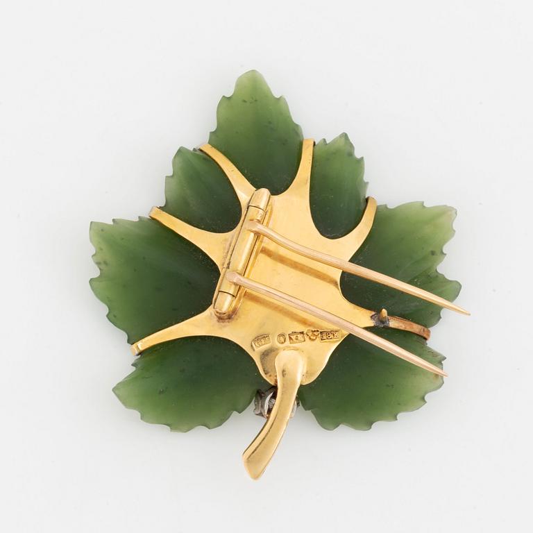 An 18K gold and nefrite Borgila brooch set with an old-cut diamond.