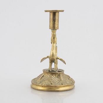 A rococo-style brass candlestick, 18th century and later.