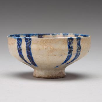 A BOWL, pottery with a white slip and underglaze blue decor, diameter ca 10 cm, Kashan, Persia/Iran early 13th century.