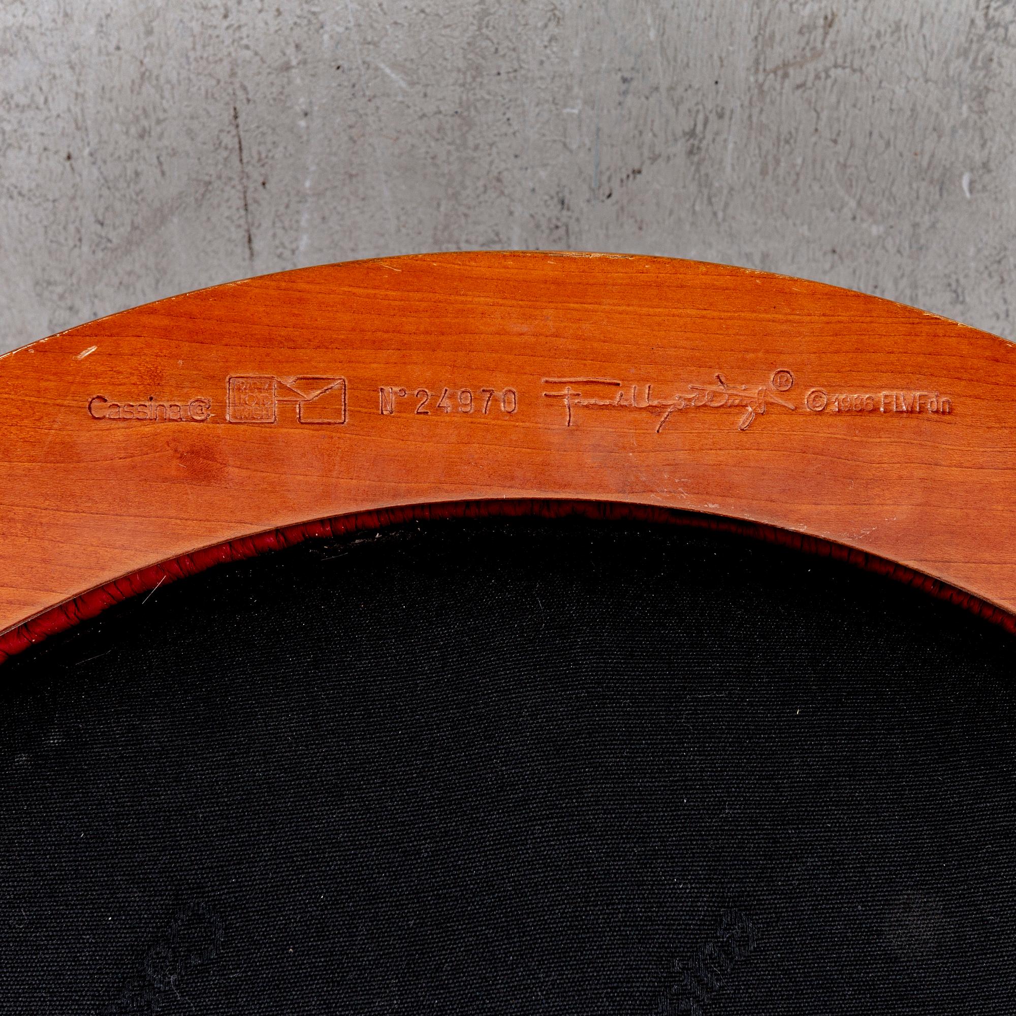 A cherry wood model 606 'Barrel' chair by Frank Lloyd Wright from Cassina.