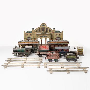 Model train with track and station building, 13 pieces, Germany, 1920s.