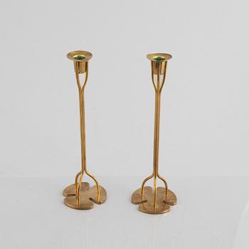 Two pairs of brass candlesticks, including 'Klöver' designed by Josef Frank for Firma Svenskt Tenn.