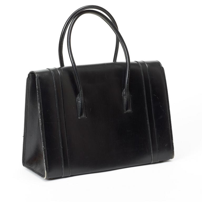 A 1950s black leather handbag by Hermès.