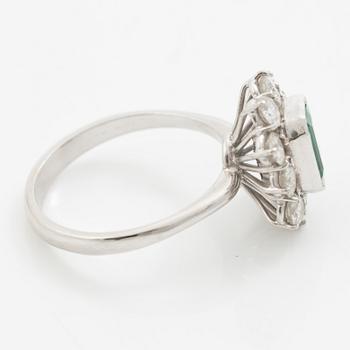 Ring 18K white gold set with a step-cut emerald and round brilliant-cut diamonds.