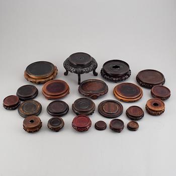 A group of 22 Chinese wooden stands, 20th century.