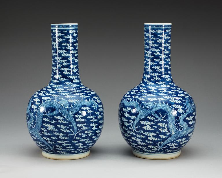 A pair of blue and white vases, late Qing dynasty, with Kangxi four character mark.