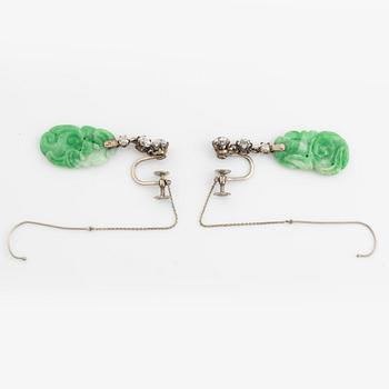 A pair of 18K white gold earrings with carved jadeite set with old-cut diamonds.