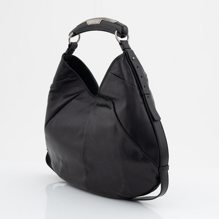Yves Saint Laurent, a black leather and horn hobo bag.