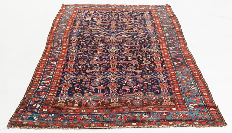 A carpet, semi-antique kurdish, circa 300 x 147 cm.