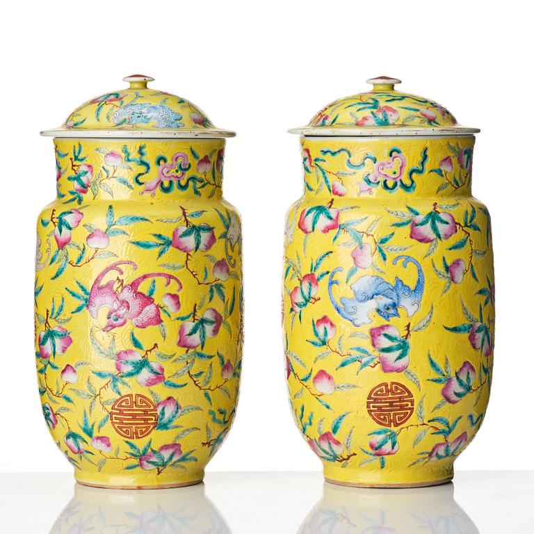 A pair of yellow glazed peach and bat vases with covers, Qing dynasty, 19th Century.