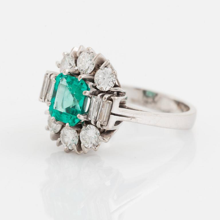 An 18K white gold ring set with a step-cut emerald.
