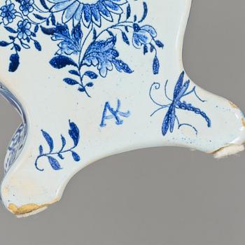 An 18th Century table clock, by Jacob Koch (1737-1805), Stockholm. Case in rococo-style, faience, marked AK.