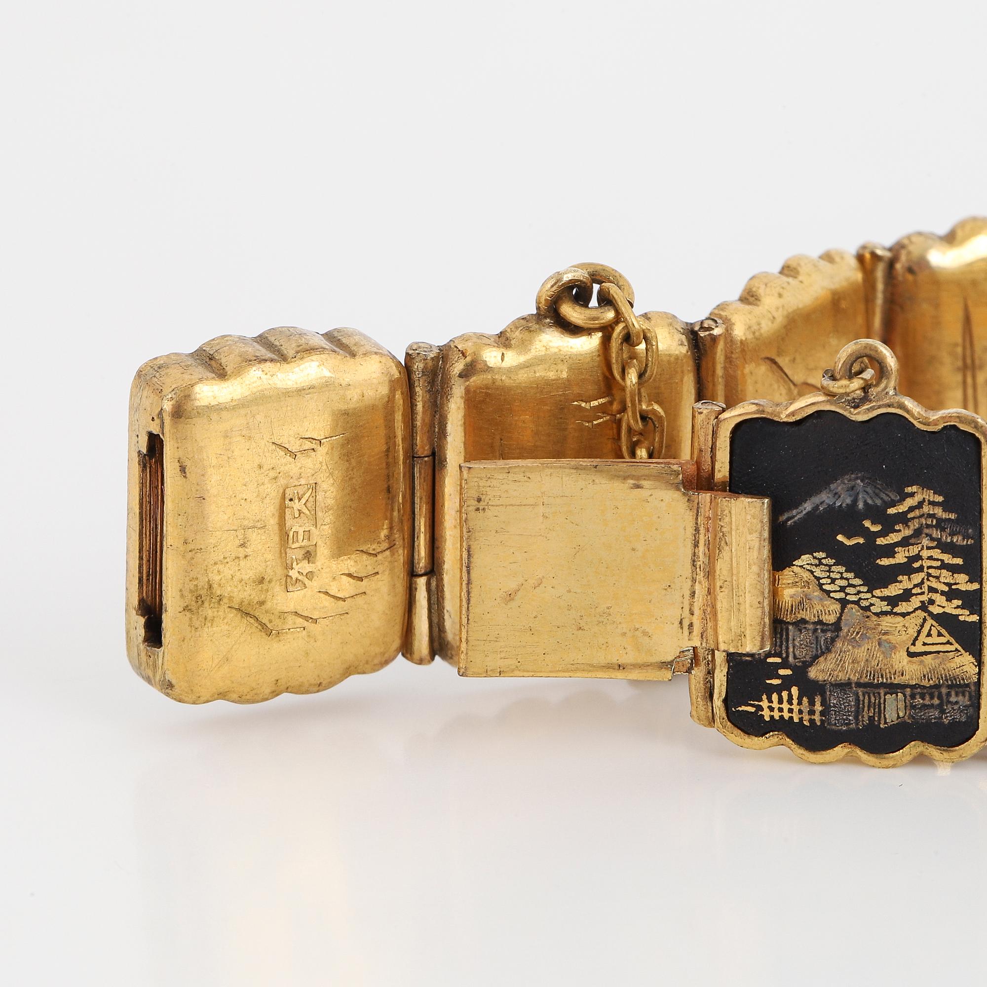 ARMBAND, gul metall med japanskt motiv.