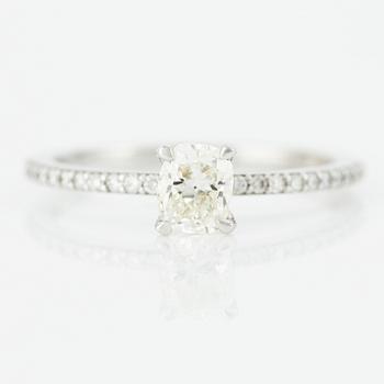 Ring with cushion-cut diamond.