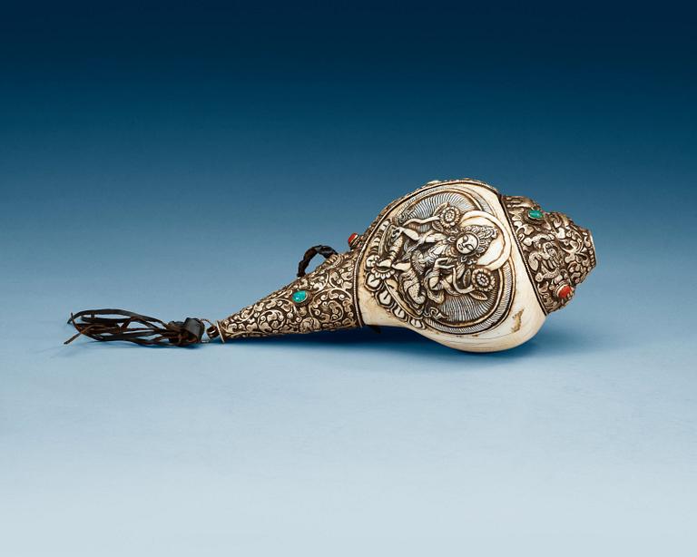 A elaborately decorated ritual Tibetan Conch-shell horn.