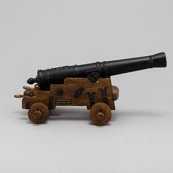 A 20th century cast iron signal cannon.