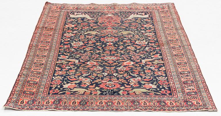 An oriental rug, signed, 126 x 205 cm.
