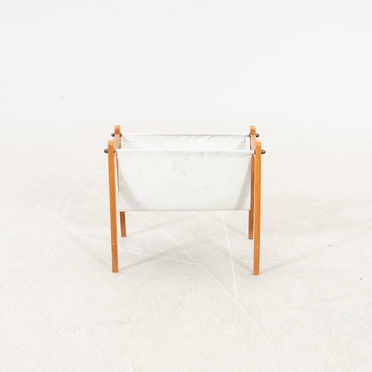 A 1960s teak newspaper holder.