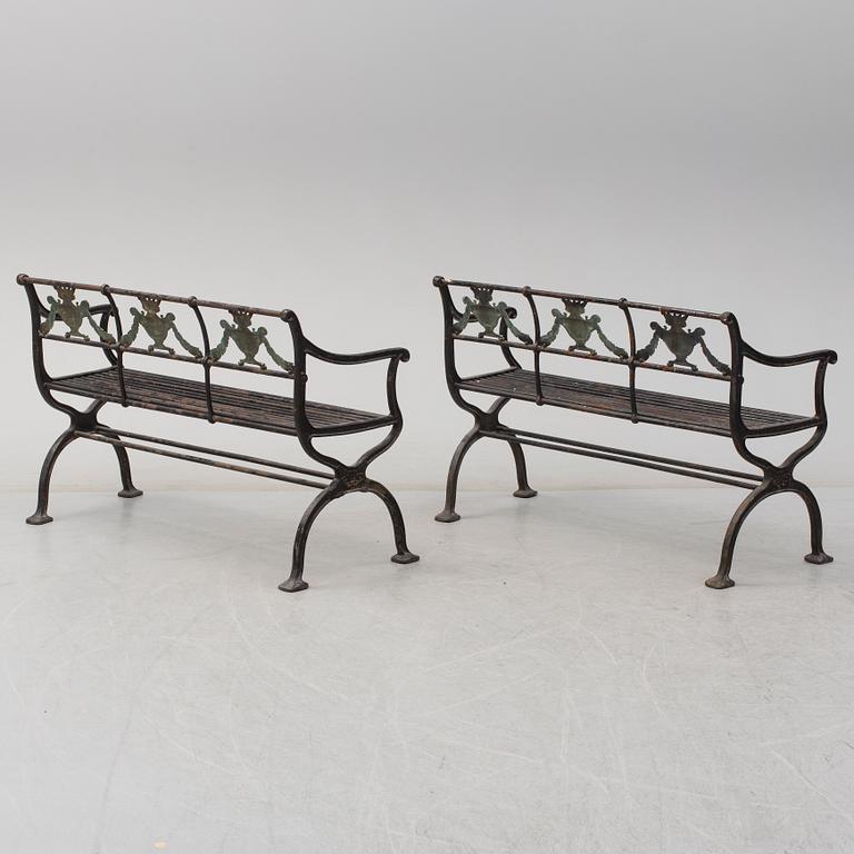 GARDEN SOFAS, a pair, cast iron, empire style, late 19th century.