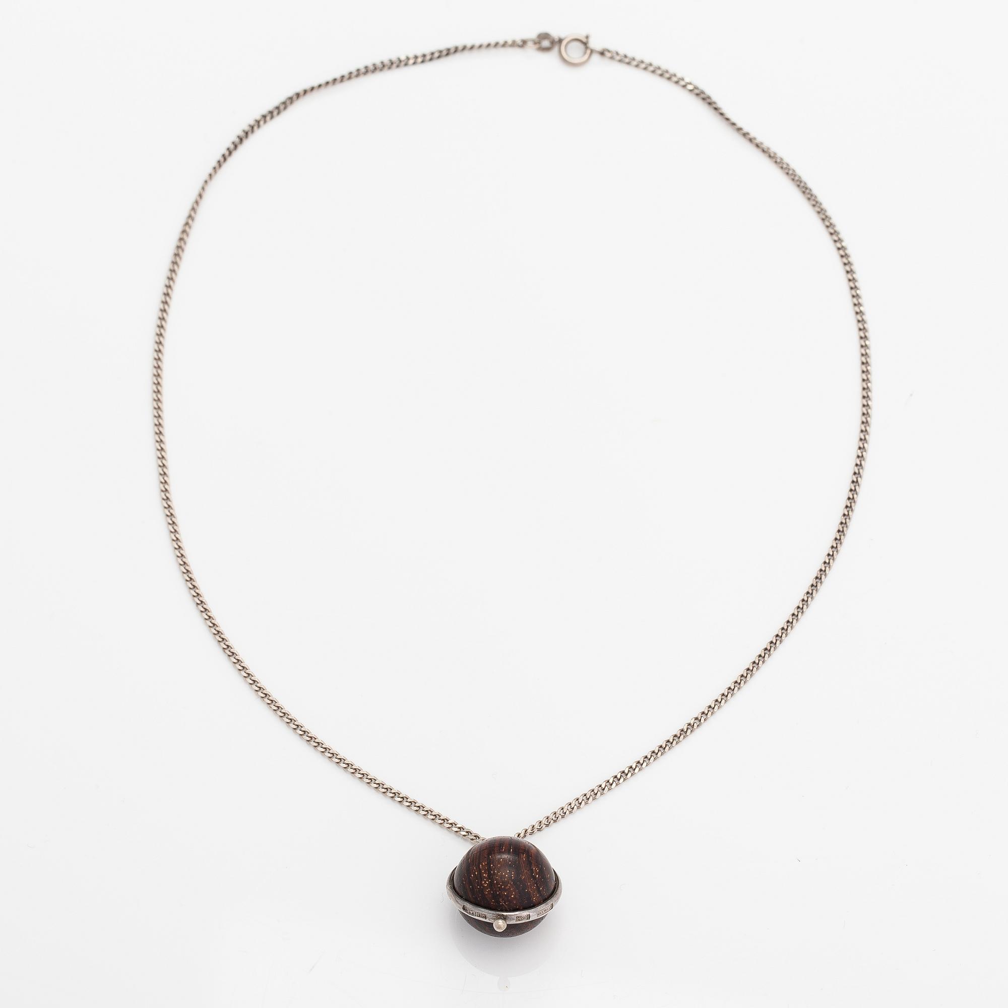 Kaija Aarikka, A necklace, a paid of earrings and a brooch made of silver and wood. Finland.