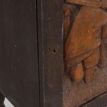 A 1920s cabinet with a relief.