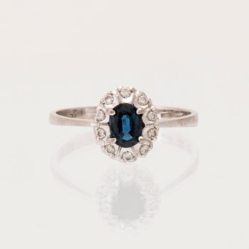 An 18K white gold carmosé ring set with an oval faceted sapphire and round brilliant-cut diamonds, Alessandria Italy.