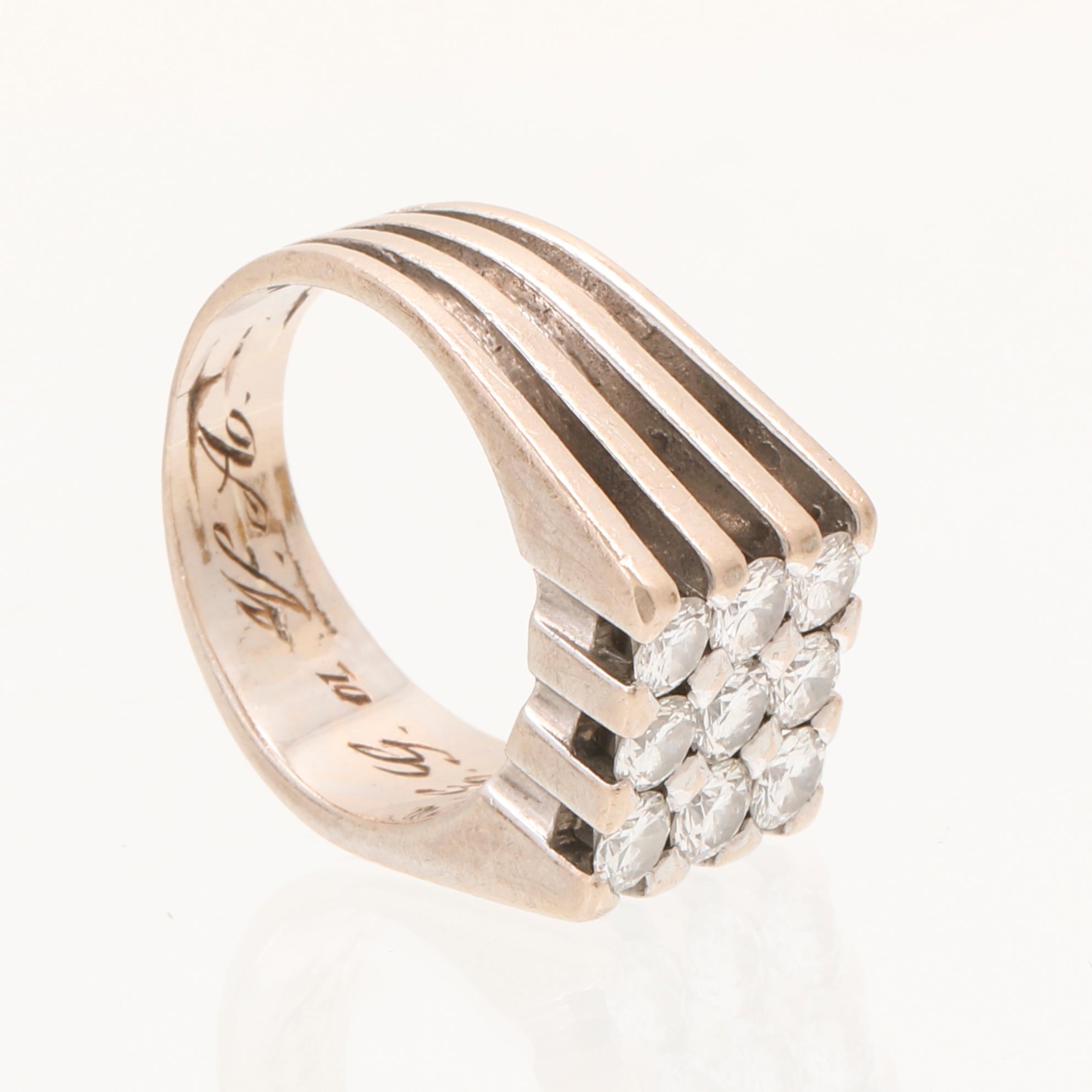 A 21K white gold ring with round briliant cut diamonds.