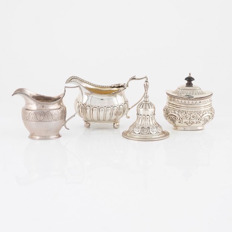 A silver bell, sugar box, and two creamers, including London 1811.