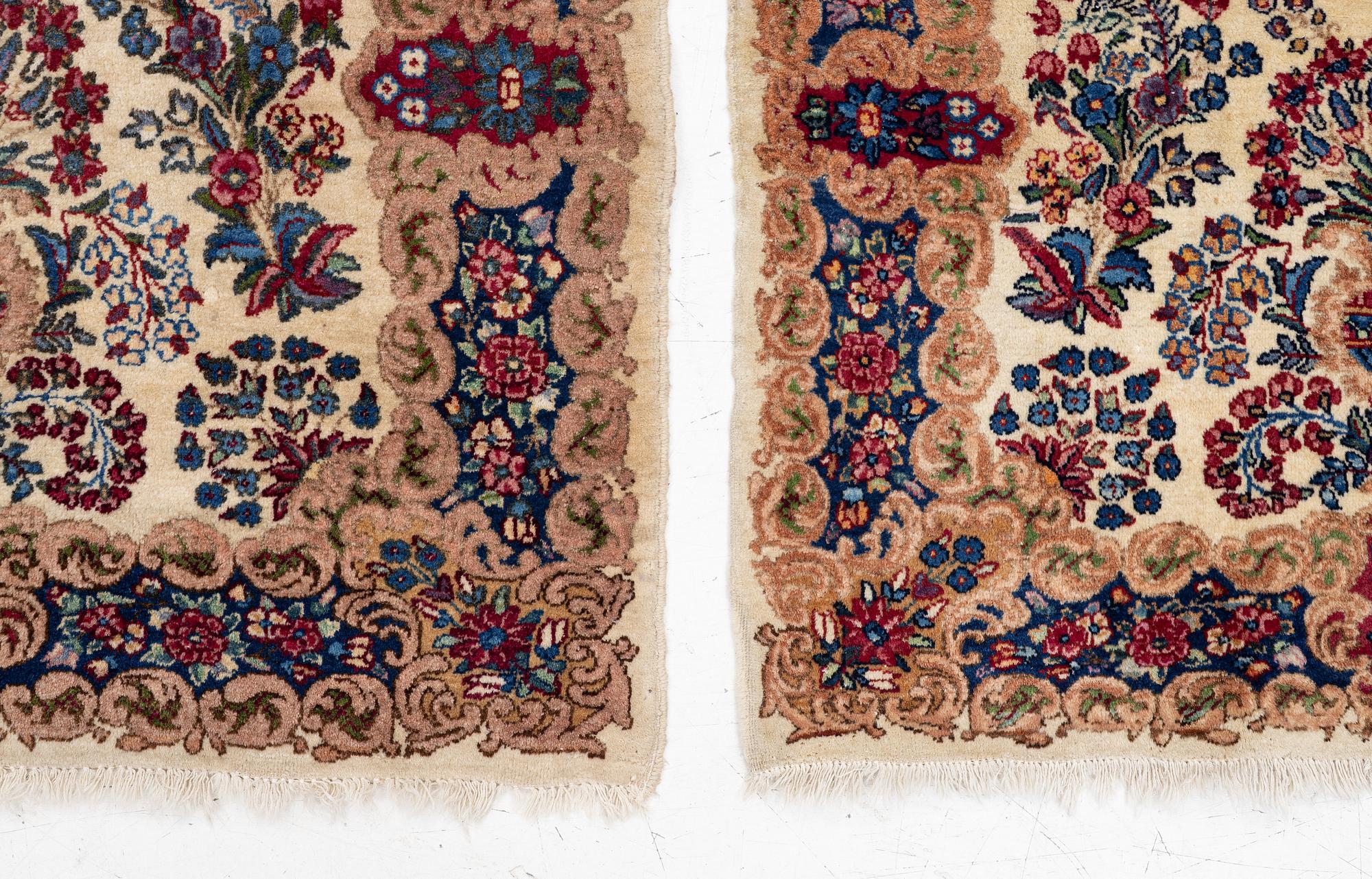 A pair of similar Kirman rugs, south Persia, c. 147 x 94 and 154 x 96 cm.