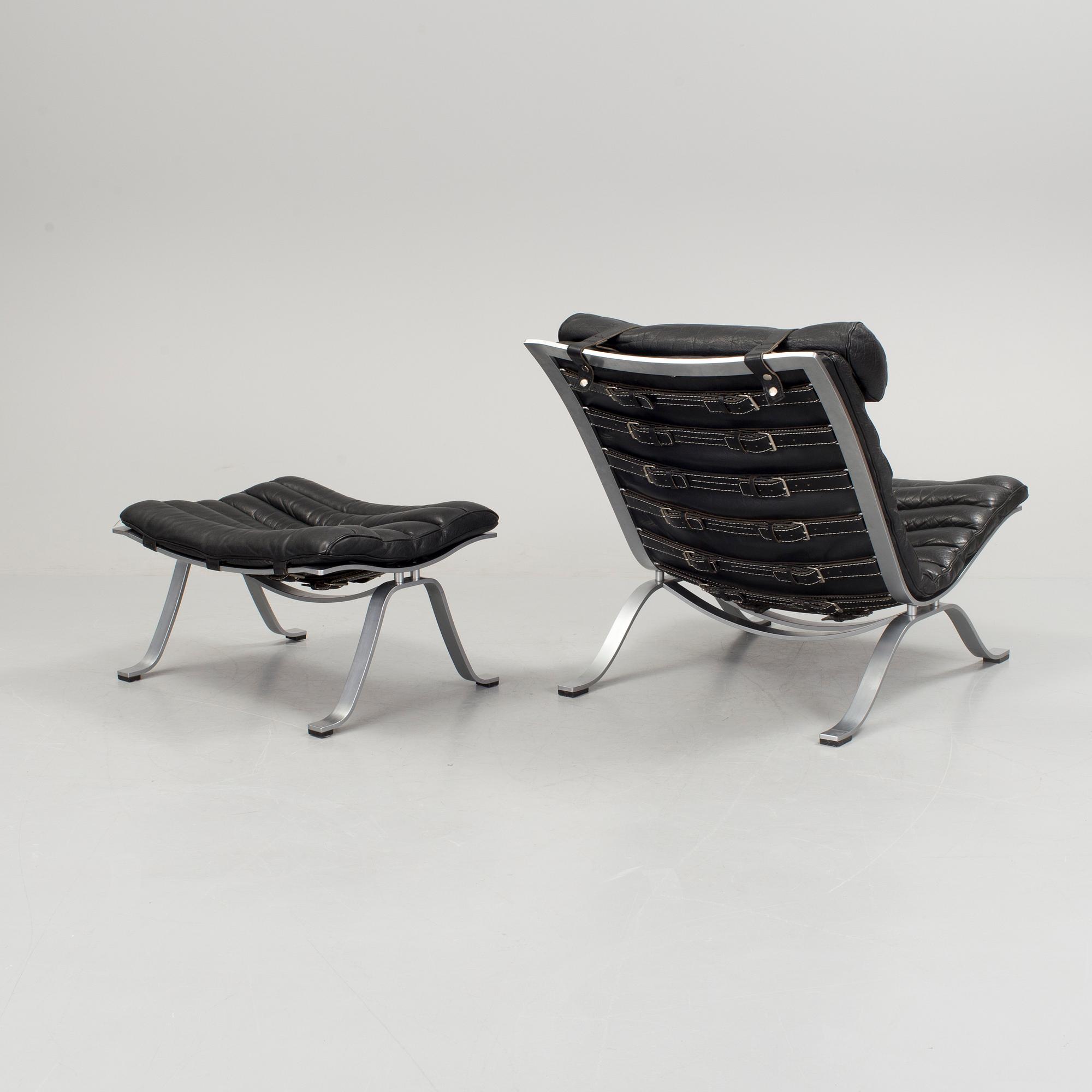 A black leather "Ari" easy chair with foot stool by Arne Norell for Norell möbler.