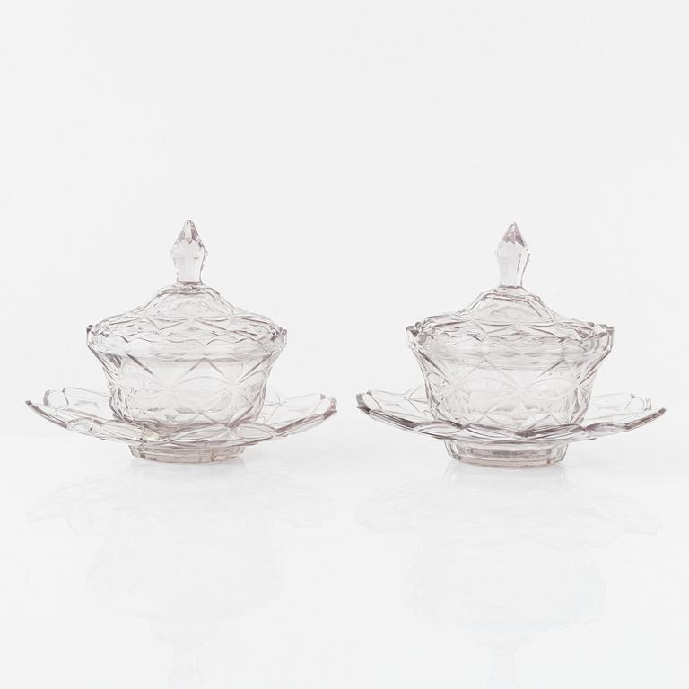 A pair of lidded glass bowls with stands, late 19th century.
