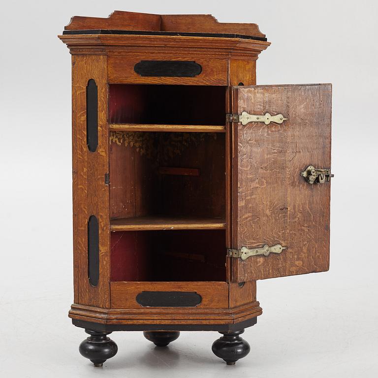 A Baroque corner cabinet, 18th Century.