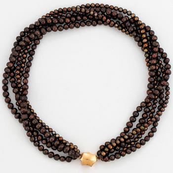 A five strand cultured pearl necklace.