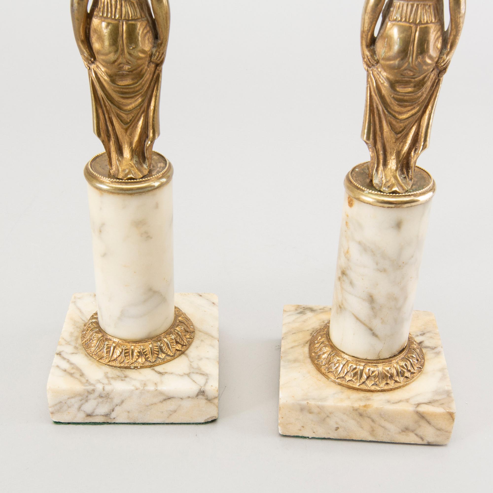 A pair of Gustavian style candle sticks around 1900.