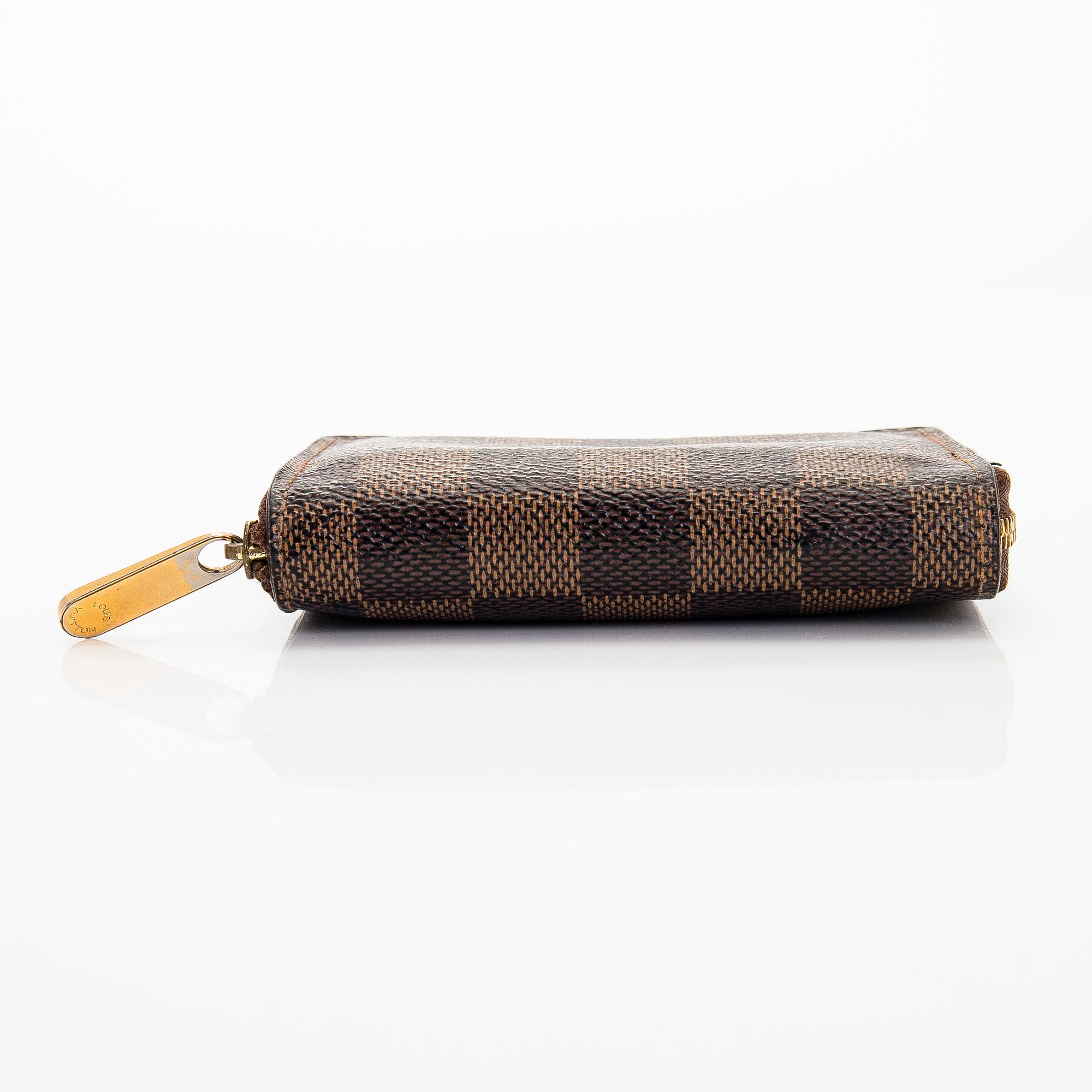 Louis Vuitton, a 'Zippy Coin Purse' wallet and an 'Inventeur' belt.