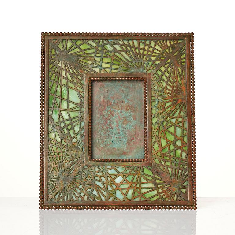 Louis Comfort Tiffany / Tiffany Studios, an Art Nouveau bronze and marbled "Pine needles" glass frame model "948", New York.