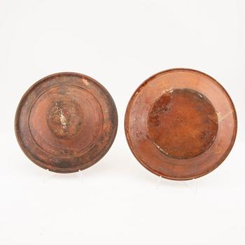 Two bowl plates ("Äggakagefat") 2 pieces from Skåne, one dated 1748 and 1891, engobed earthenware.