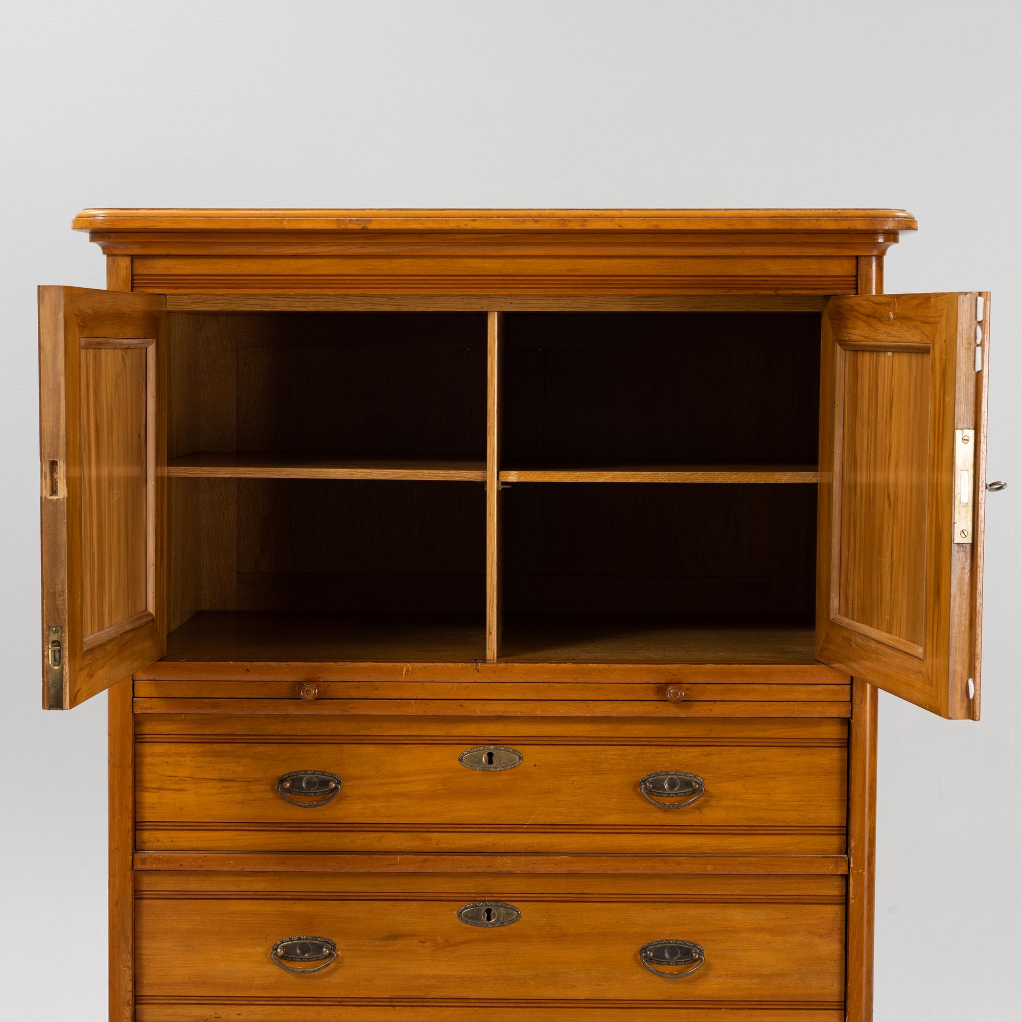 A walnut veneered tall boy dresser, early 20th century.
