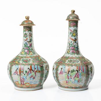 Two famille rose 'Canton' vases with covers, Qing dynasty, 19th century.