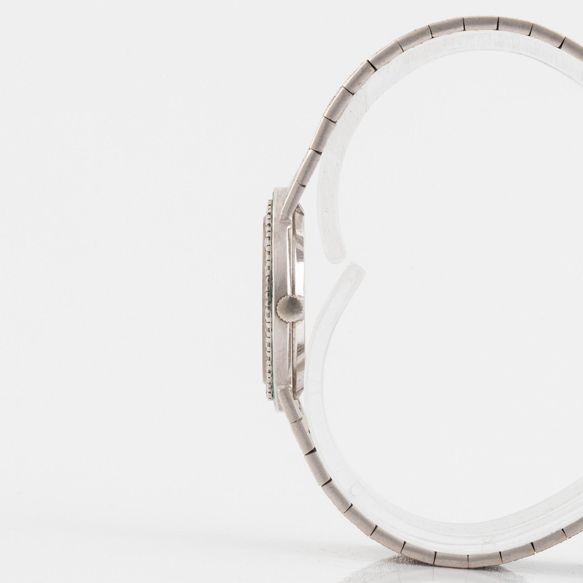 Piaget armbandsur 18K vitguld med runda briljantslipade diamanter samt smaragder.