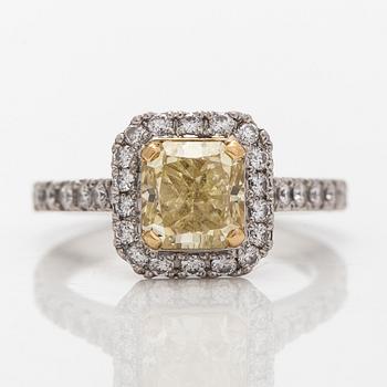 platinum ring with yellow radiant-cut diamond and brilliant cut diamonds.