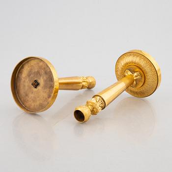 A pair of gilt-bronze Emnpire style candlesticks in the manner of Claude Galle, 19th century.