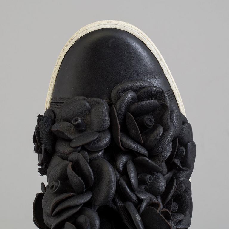 A black leather sneakers by Chanel.