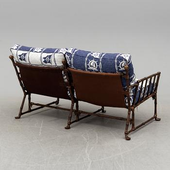 A contemporary bamboo imitating garden sofa.